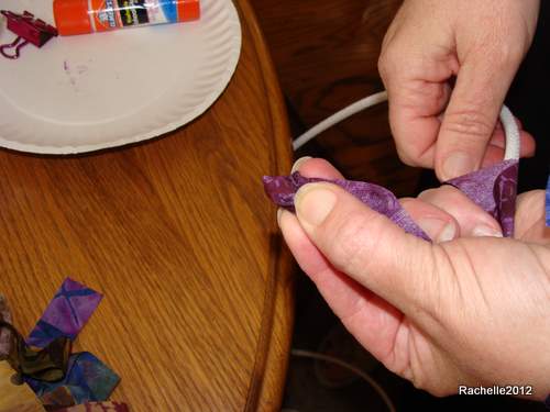 fold the 2 wings of fabric nicely around the end of the cord